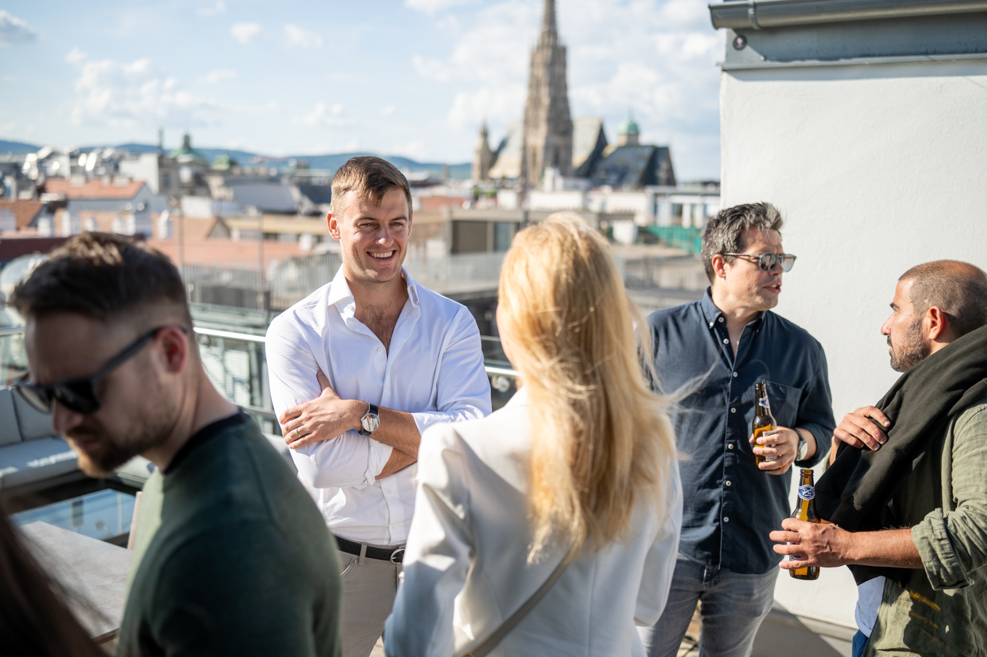 Cyclops team chatting over drinks on the rooftop