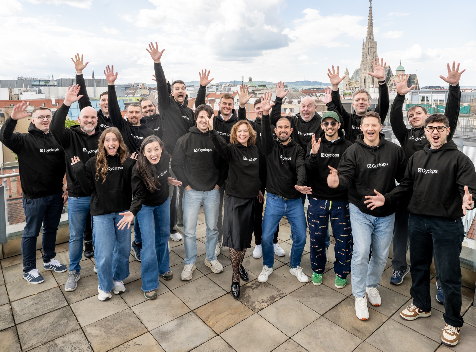 The Cyclops team waving on a Vienna rooftop